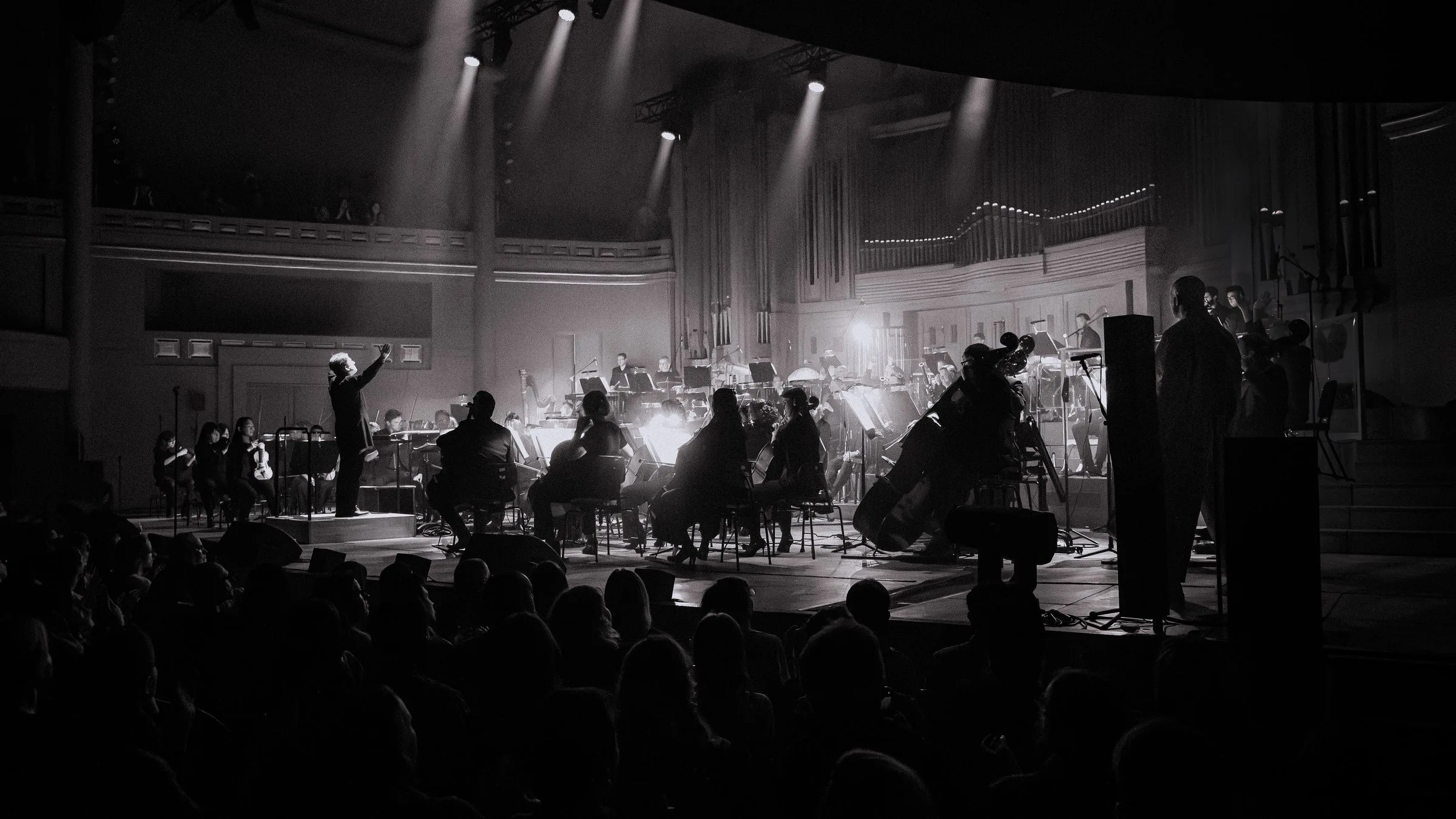 L’orchestre sur scène vu de la salle, en noir et blanc
