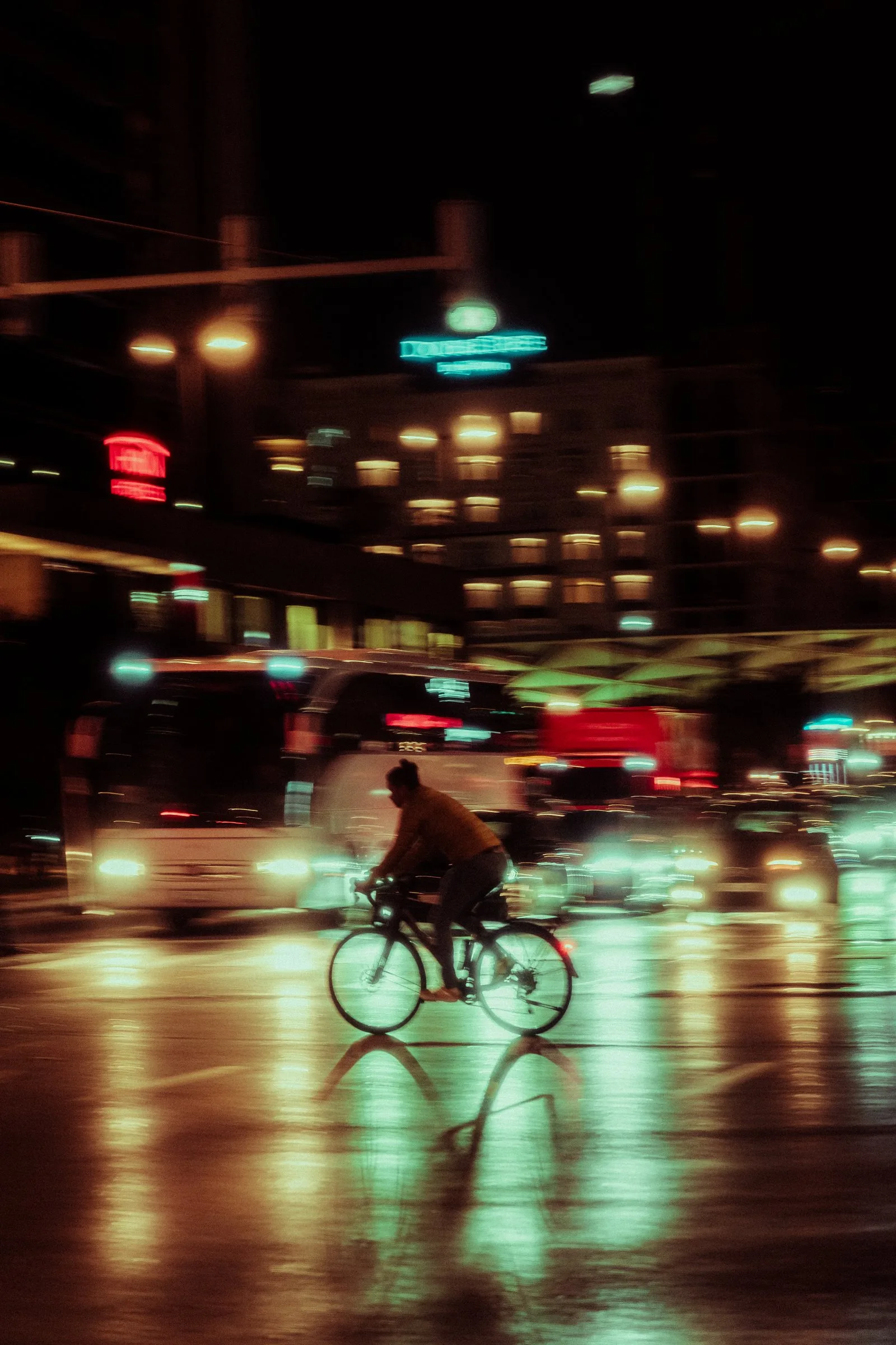 Un cycliste sous les lumières de la ville, la nuit